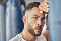 Tired boxer taking a break from cardio routine. Portrait of exhausted mma fighter leaning on punching bag. Bodybuilder