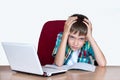 Tired boy holding his head to do homework. Child with learning difficulties. Education concept, back to school Royalty Free Stock Photo