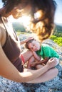 The tired boy lies on his mother`s feet. Royalty Free Stock Photo