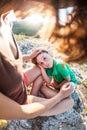 The tired boy lies on his mother`s feet. Royalty Free Stock Photo