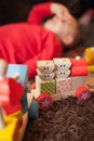 Tired boy playing with a wooden toy train Royalty Free Stock Photo