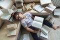 Tired boy sleeping surrounded by books in room Royalty Free Stock Photo