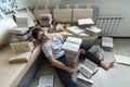 Tired boy sleeping surrounded by books in room Royalty Free Stock Photo