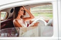 Tired bride sitting in a classic car Royalty Free Stock Photo