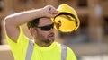 Tired builder, hard work concept. Hispanic 40 s worker builder on site construction. American middle aged man worker Royalty Free Stock Photo