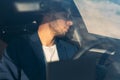 Tired business man falling asleep sitting inside her car seen through windshield Royalty Free Stock Photo