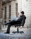 Tired Business Man sitting on Office Chair on Street sleeping Royalty Free Stock Photo