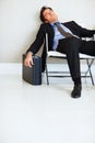 Tired business man sleeping on chair with copyspace. Tired business executive sleeping on chair with copyspace. Royalty Free Stock Photo