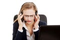 Tired business woman at call center sitting by the table. Royalty Free Stock Photo