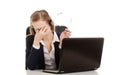 Tired business woman at call center sitting by the table. Royalty Free Stock Photo