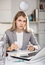 Tired business woman drinking headache pills in office Royalty Free Stock Photo