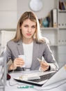 Tired business woman drinking headache pills in office Royalty Free Stock Photo