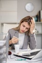 Tired business woman drinking headache pills in office Royalty Free Stock Photo