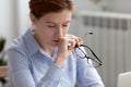 Tired business woman holding glasses taking break for eyes rest Royalty Free Stock Photo