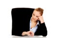 Tired business woman sitting behind the desk Royalty Free Stock Photo