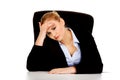 Tired business woman sitting behind the desk Royalty Free Stock Photo