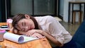 Tired business woman sleeping on office desk in front of laptop computer. Royalty Free Stock Photo