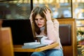 Tired business woman working on her workspace.Angry girl student in cafe with laptop