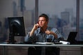 Businessman on call working overtime Royalty Free Stock Photo
