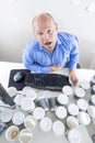 Tired businessman drinks too much coffee at office