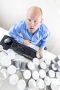 Tired businessman drinks too much coffee at office