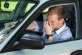 Tired businessman driving a car