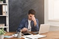 Tired businessman with laptop in modern white Royalty Free Stock Photo