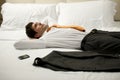 Tired Businessman Lying on Bed Royalty Free Stock Photo