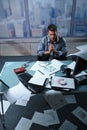 Tired businessman with papers all around Royalty Free Stock Photo