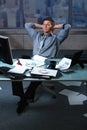 Tired businessman with papers all around Royalty Free Stock Photo