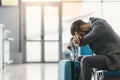 tired businessman sleeping at airport lobby while waiting Royalty Free Stock Photo