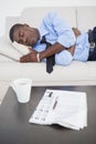 Tired businessman sleeping on the sofa Royalty Free Stock Photo