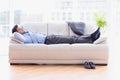 Tired businessman sleeping on a sofa Royalty Free Stock Photo