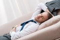 Tired businessman sleeping on a sofa in shirt Royalty Free Stock Photo