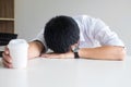 Tired businessman sleeping at work in modern office with hand ho Royalty Free Stock Photo