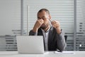 Exhausted male employee massage eyes suffering from headache