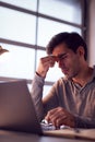 Tired Businessman Working Late Using Laptop At Desk In Office Rubbing Eyes Royalty Free Stock Photo