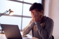 Tired Businessman Working Late Using Laptop At Desk In Office Rubbing Eyes Royalty Free Stock Photo