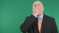 Tired Businessman Yawning With Green Screen In Background