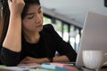 tired businesswoman with hand on head at office. frustrated young woman with headache at workplace. exhausted startup in Royalty Free Stock Photo