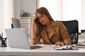 Tired businesswoman holding covering her head, feeling strong headache, exhausted from overwork or stress at work Royalty Free Stock Photo