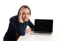 Tired businesswoman with laptop at the desk Royalty Free Stock Photo