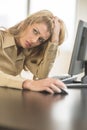 Tired Businesswoman Looking Away While Sitting At Computer Desk Royalty Free Stock Photo