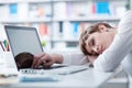 Tired businesswoman sleeping on her desk Royalty Free Stock Photo
