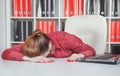 Tired businesswoman sleeping in office Royalty Free Stock Photo