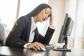 Tired Businesswoman Using Computer At Desk Royalty Free Stock Photo