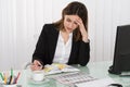 Tired Businesswoman Writing Schedule In Diary Royalty Free Stock Photo