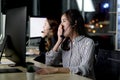 Tired call center Asian woman staff with headphone yawning during working at customer service consultant, feeling sleepy after Royalty Free Stock Photo