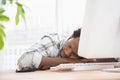 Tired casual businessman sleeping on keyboard Royalty Free Stock Photo