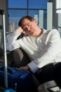 Tired Caucasian businessman sleeping at airport terminal Royalty Free Stock Photo